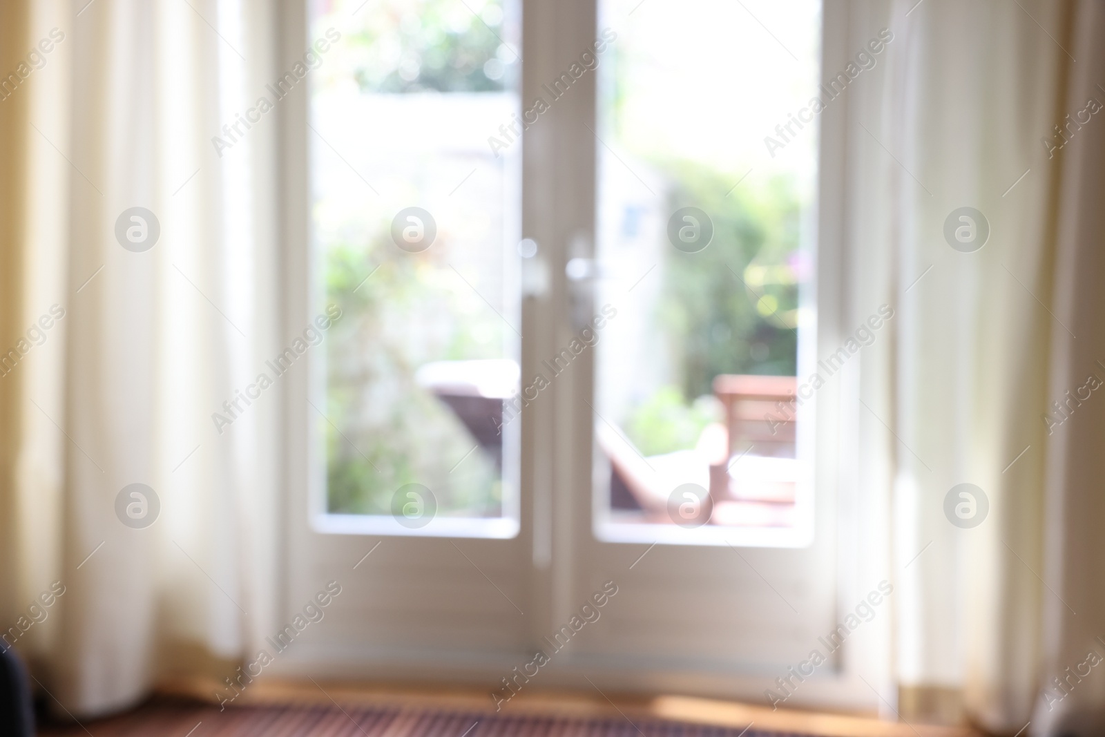 Photo of Blurred view of glass door at home