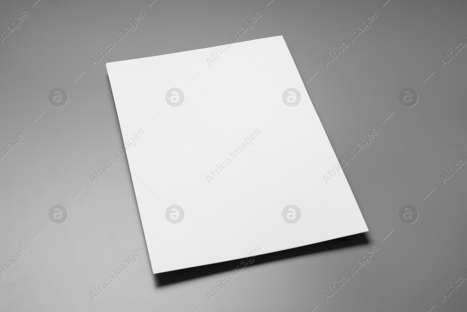 Photo of Blank paper sheets for brochure on grey background. Mock up