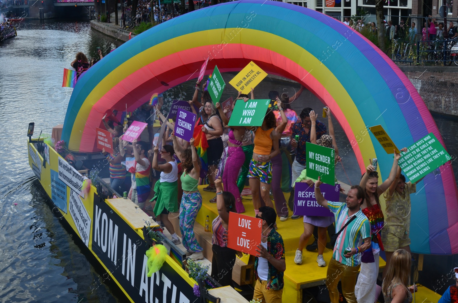 Photo of AMSTERDAM, NETHERLANDS - AUGUST 06, 2022: Many people in boat at LGBT pride parade on river