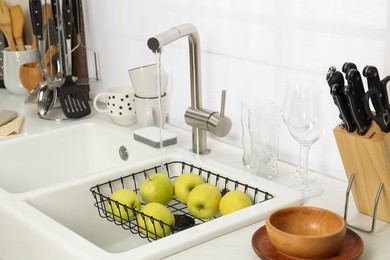 Photo of Kitchen counter with sink and cooking utensils