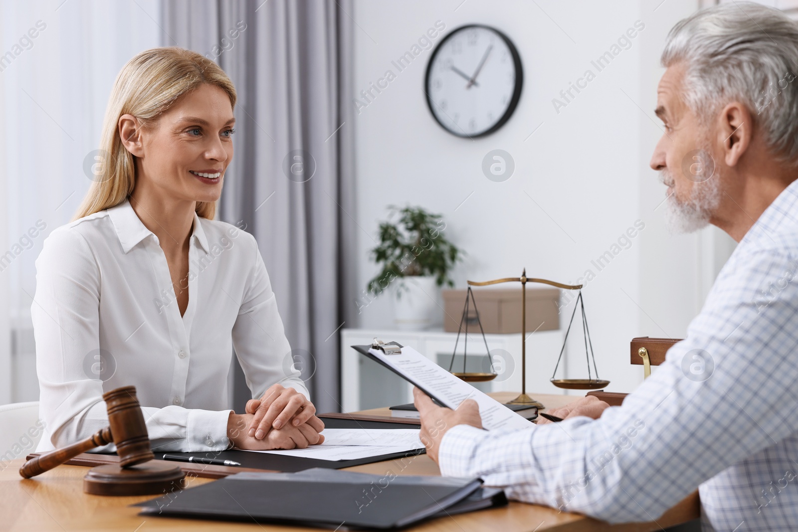 Photo of Senior man having meeting with lawyer in office