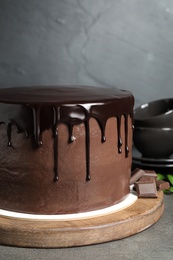 Photo of Freshly made delicious chocolate cake on table against grey background