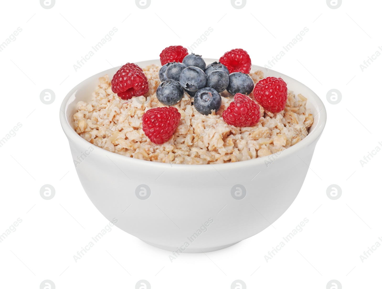 Photo of Tasty boiled oatmeal with berries in bowl isolated on white