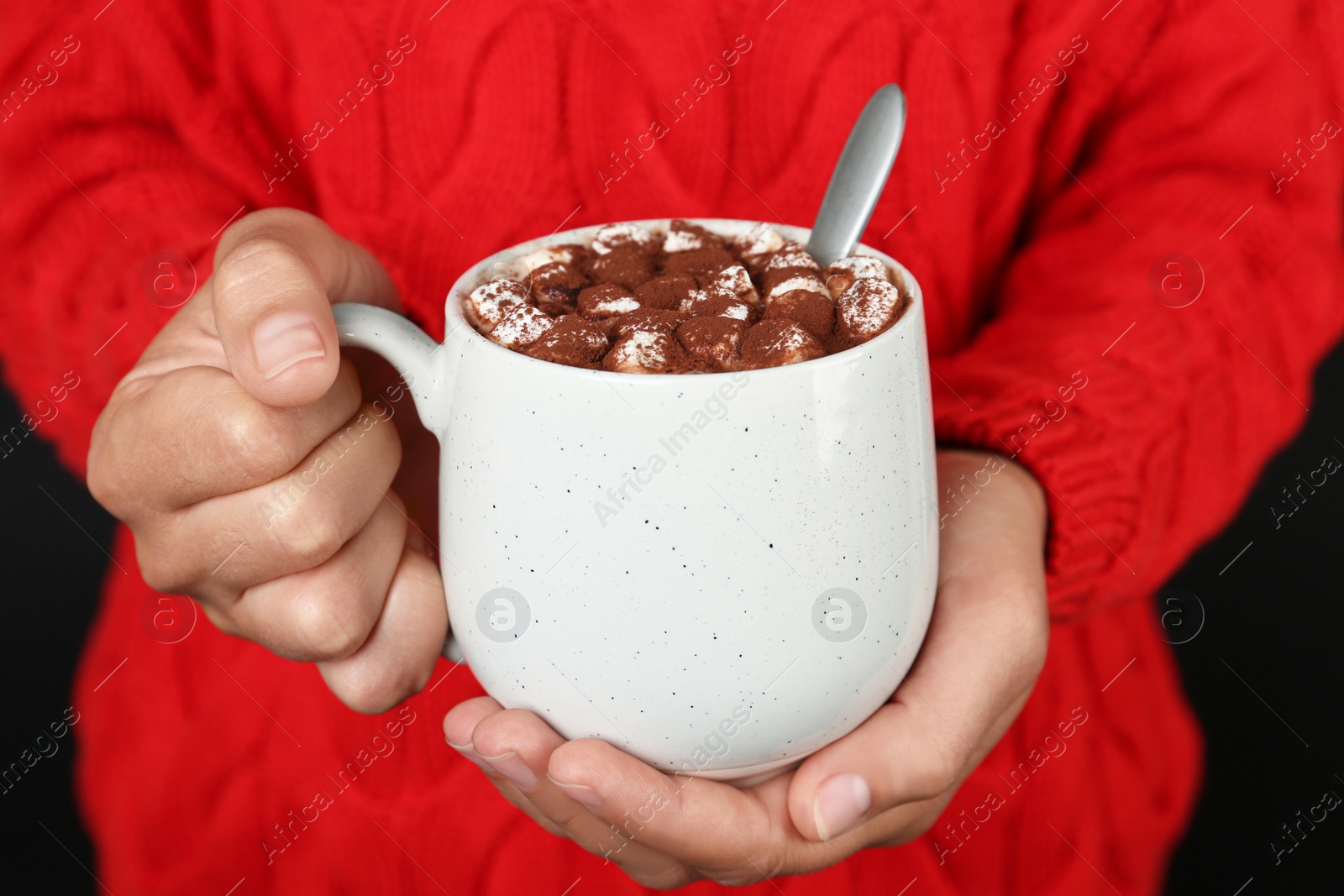 Photo of Woman holding cup of delicious hot cocoa drink with marshmallows, closeup
