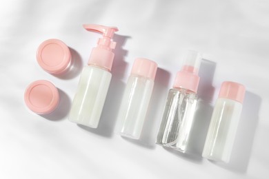 Photo of Cosmetic travel kit on white background, top view