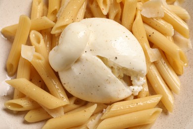 Photo of Plate of delicious pasta with burrata as background, closeup