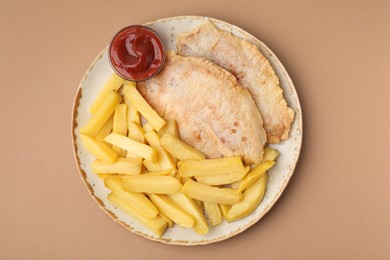 Delicious fish and chips with ketchup on light brown table, top view