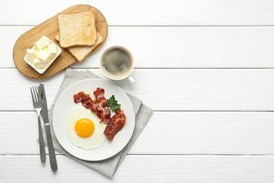 Photo of Delicious breakfast with sunny side up egg served on white wooden table, flat lay. Space for text