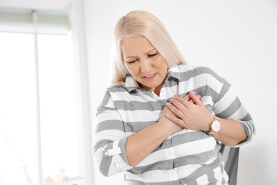 Mature woman having heart attack at home