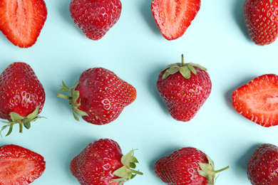 Photo of Tasty ripe strawberries on light blue background, flat lay