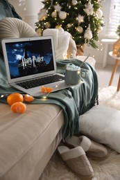 MYKOLAIV, UKRAINE - DECEMBER 25, 2020: Laptop displaying Harry potter movie indoors. Cozy winter holidays atmosphere