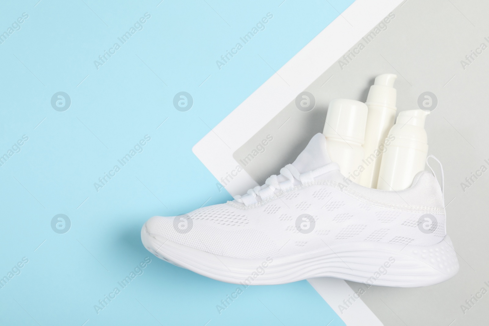 Photo of Stylish footwear with shoe care accessories on color background, top view