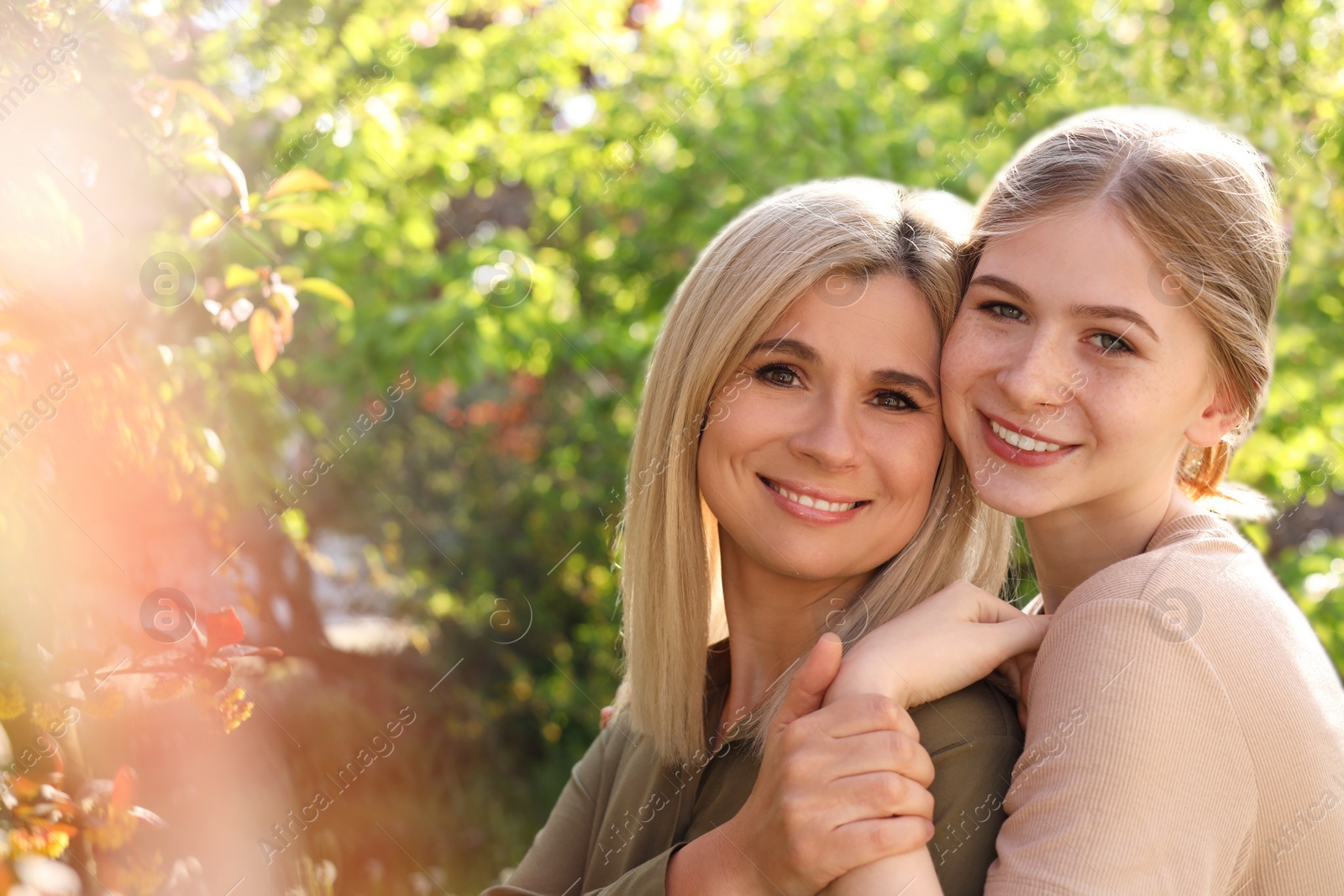 Photo of Happy mother with her daughter spending time together in park on sunny day