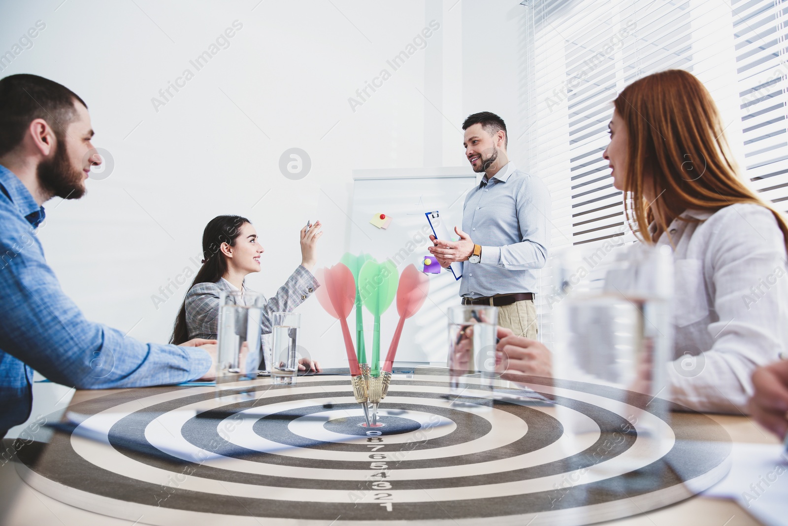 Image of People having business meeting and dart board with arrows. Double exposure