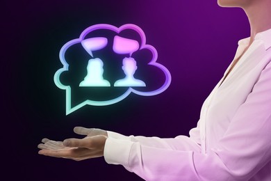 Image of Productive dialogue, meaningful conversation. Woman holding illustration of thought cloud with people and speech bubbles on violet black gradient background, closeup