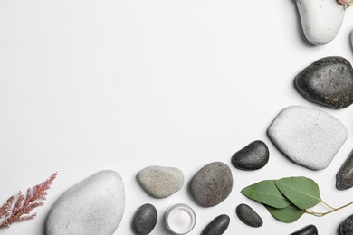 Photo of Flat lay composition with spa stones and space for text on white background