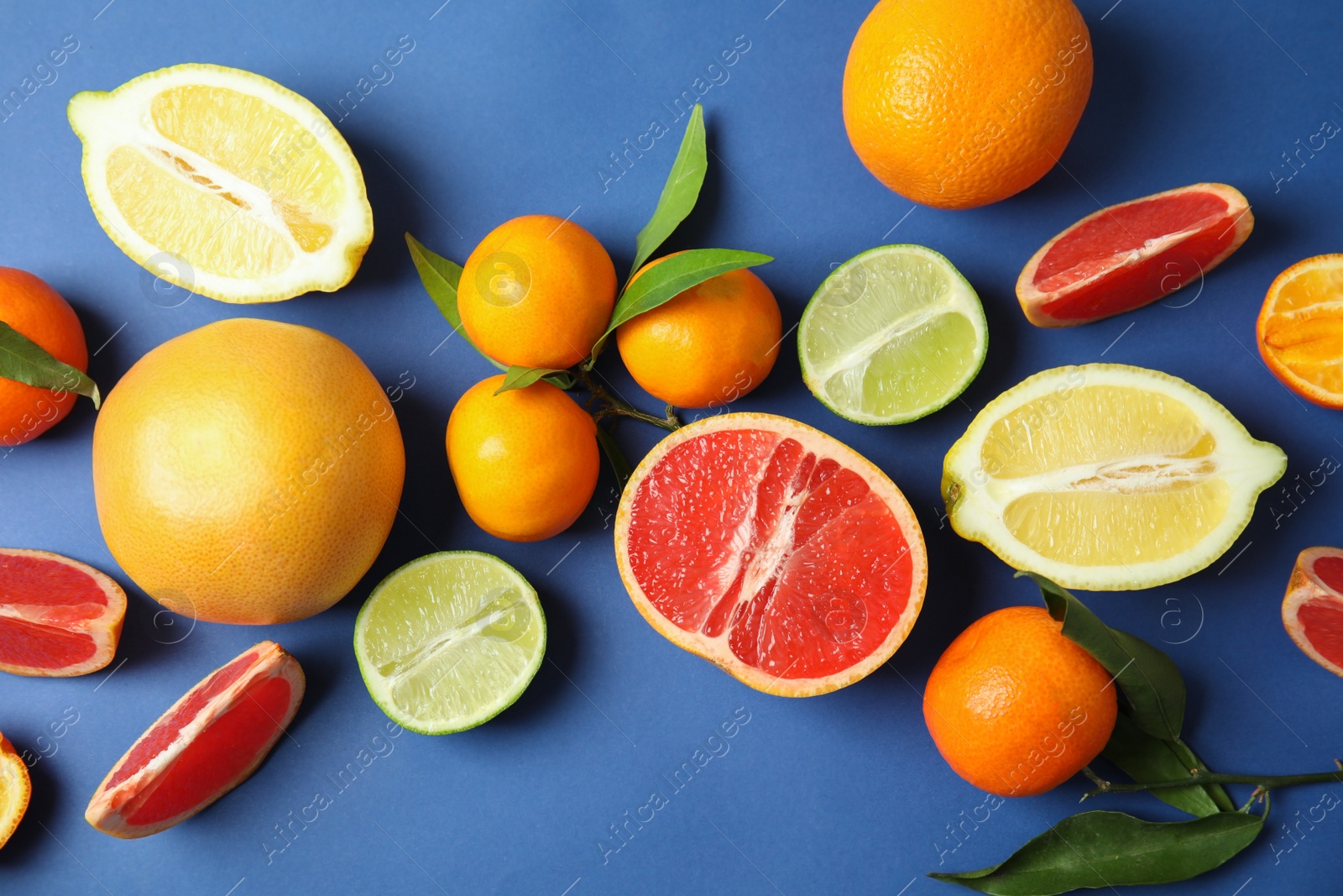 Photo of Different citrus fruits on color background, top view