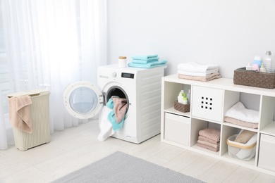 Photo of Bathroom interior with towels and washing machine