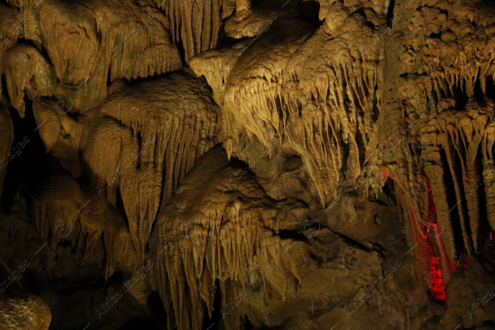 Photo of Picturesque view of many stalactite formations in cave