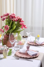 Photo of Festive table setting with beautiful flowers. Easter celebration