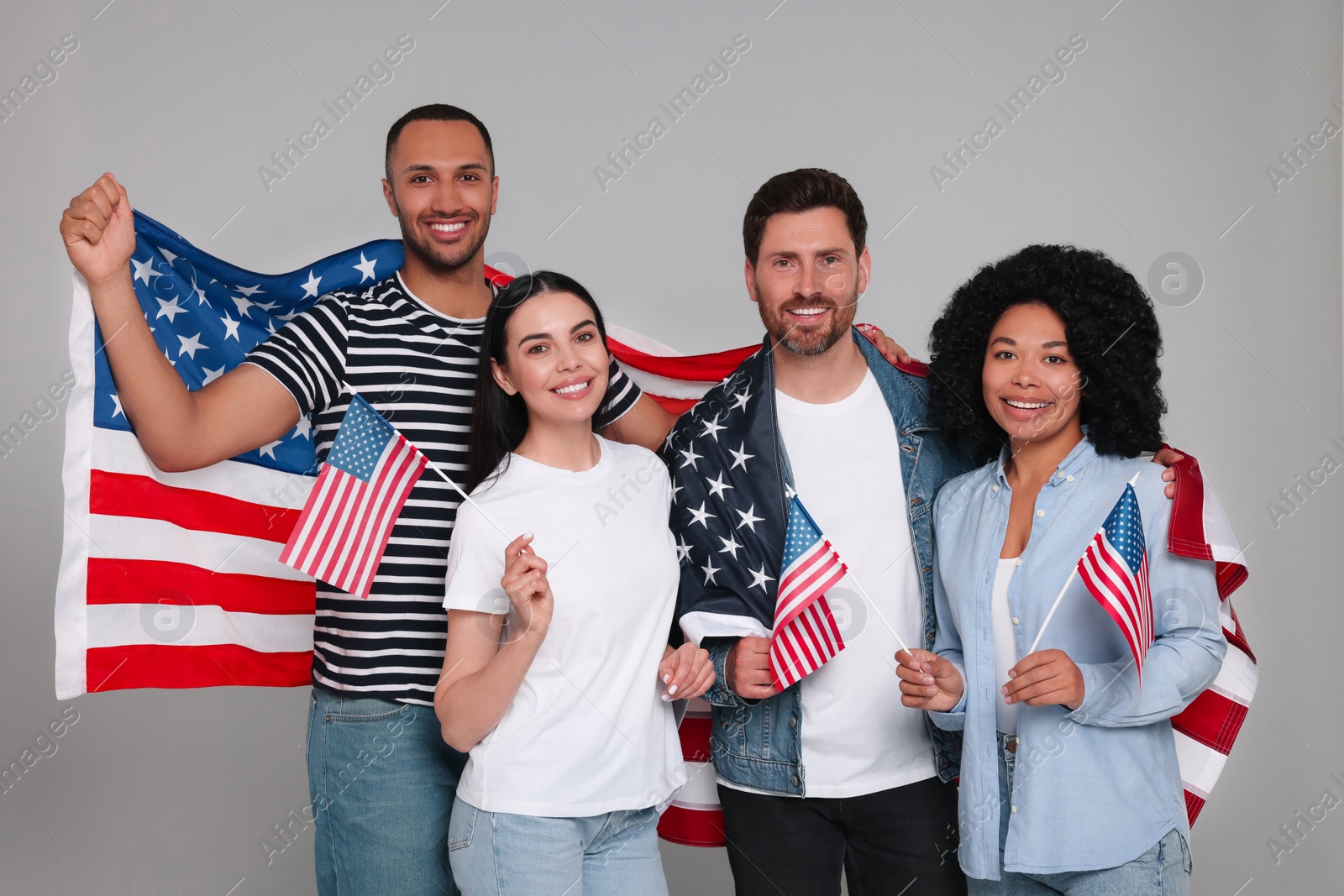 Photo of 4th of July - Independence Day of USA. Happy friends with American flags on grey background