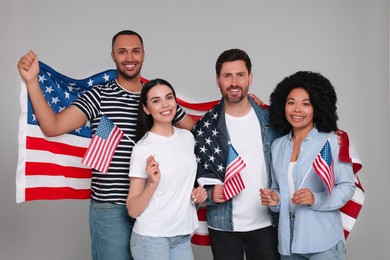 Photo of 4th of July - Independence Day of USA. Happy friends with American flags on grey background