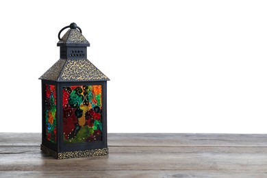 Photo of Decorative Arabic lantern on wooden table against white background