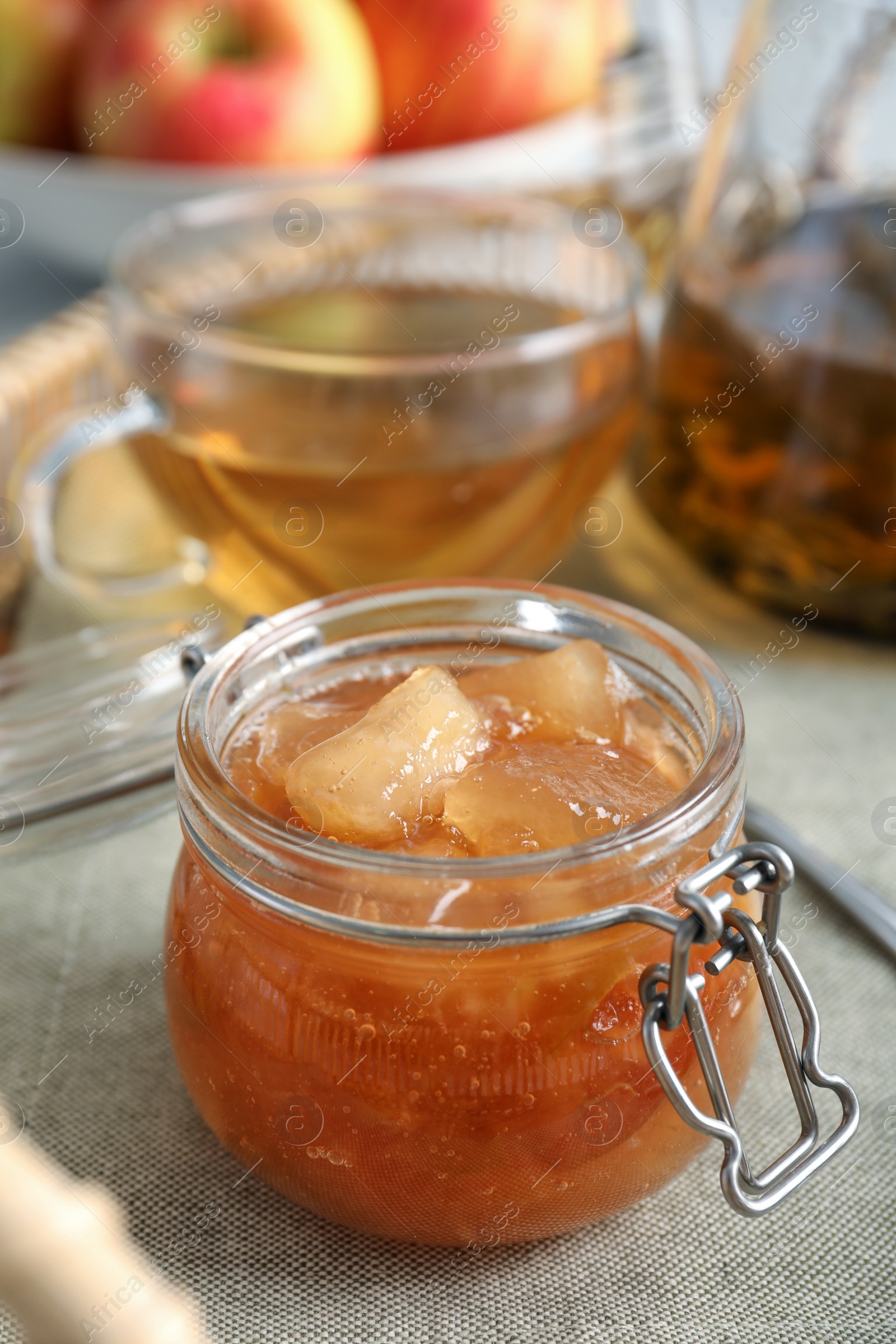 Photo of Delicious apple jam in jar on table, closeup