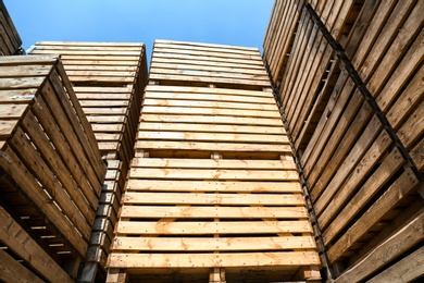 Pile of empty wooden crates outdoors on sunny day