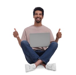 Happy man with laptop showing thumbs up on white background