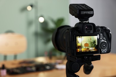 Beauty blogger's workplace. Cosmetic products on table indoors, focus on camera