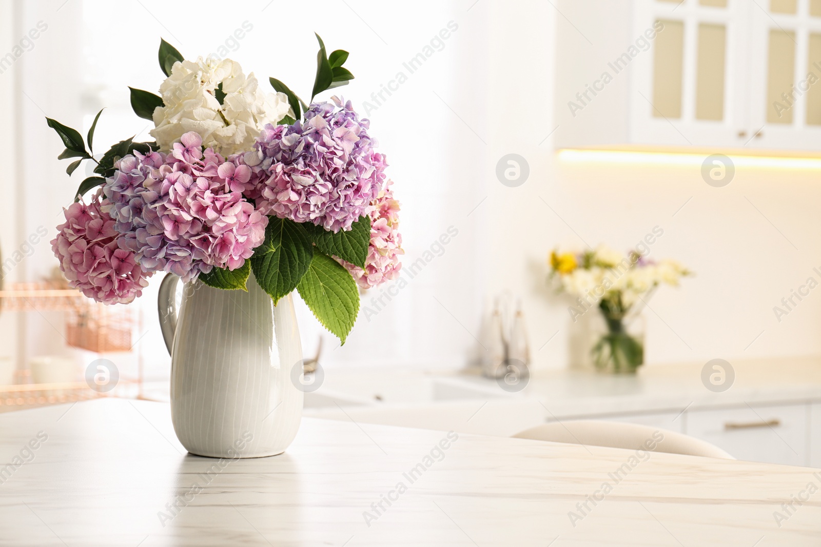 Photo of Bouquet with beautiful hydrangea flowers on white marble table. Space for text