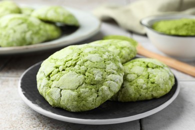 Tasty matcha cookies on tiled table, closeup