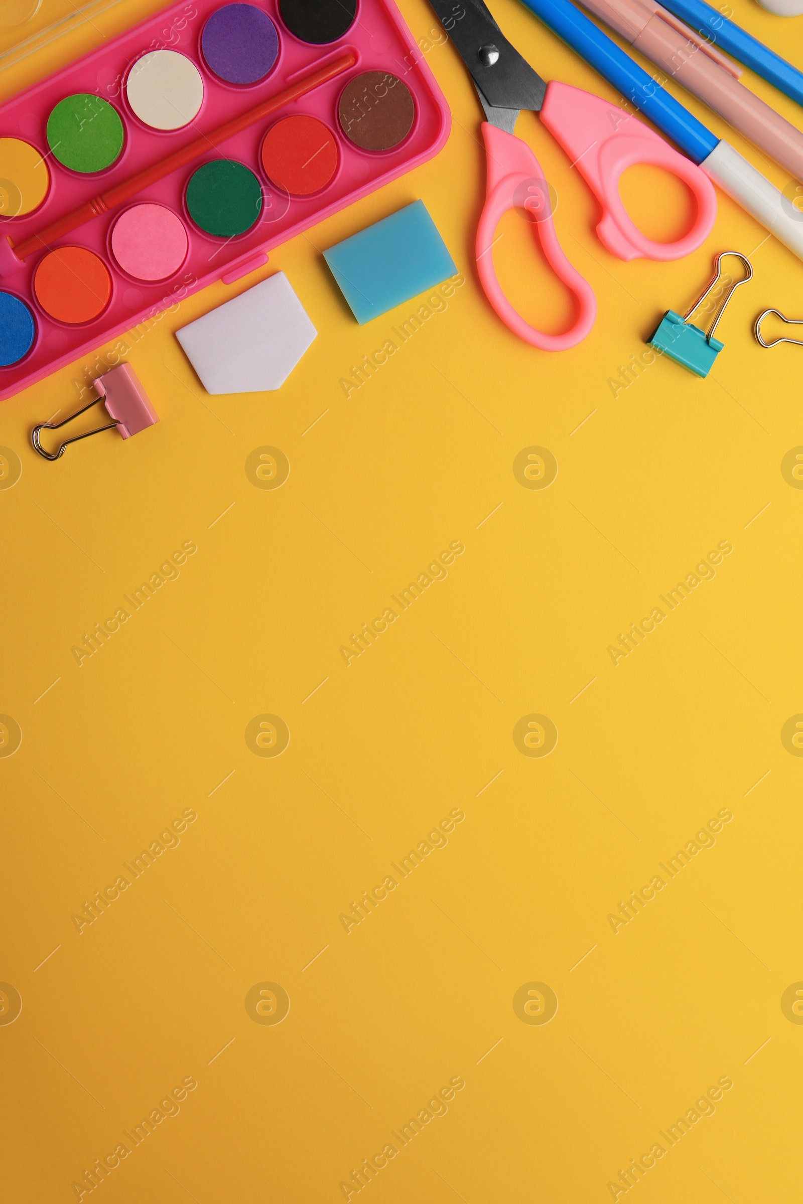 Photo of Flat lay composition with different school stationery on orange background, space for text. Back to school