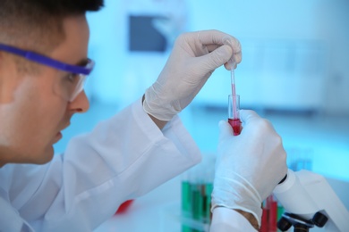 Medical student working in modern scientific laboratory, closeup