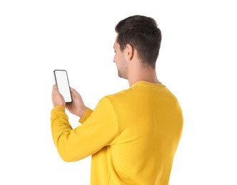 Photo of Man holding smartphone with blank screen on white background