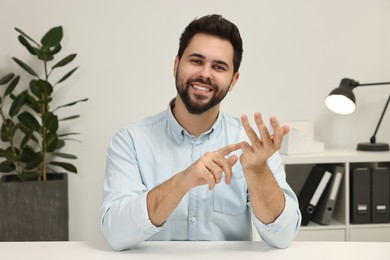 Photo of Young man having video chat indoors, view from web camera