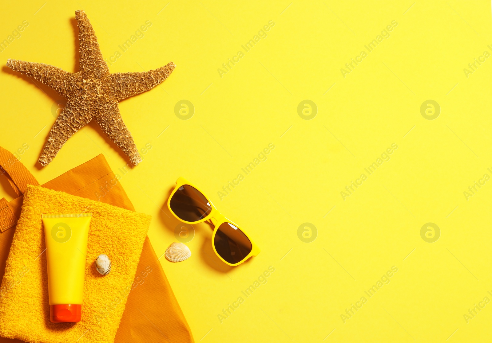 Photo of Flat lay composition with beach accessories on color background. Space for text