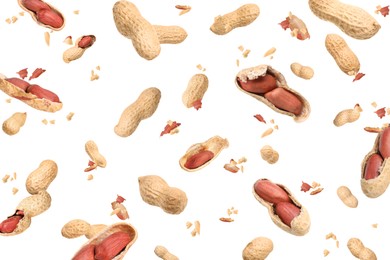 Image of Unpeeled peanuts in air on white background