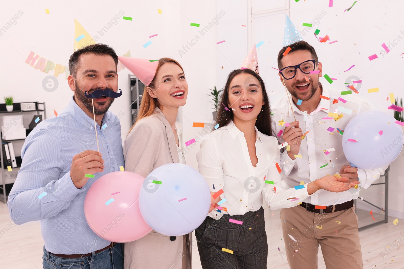 Photo of Coworkers having fun during office party indoors