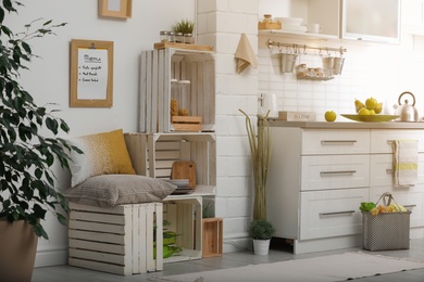 Photo of Modern kitchen interior with wooden crates as eco furniture