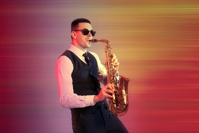 Image of Young man in elegant outfit playing saxophone on color background