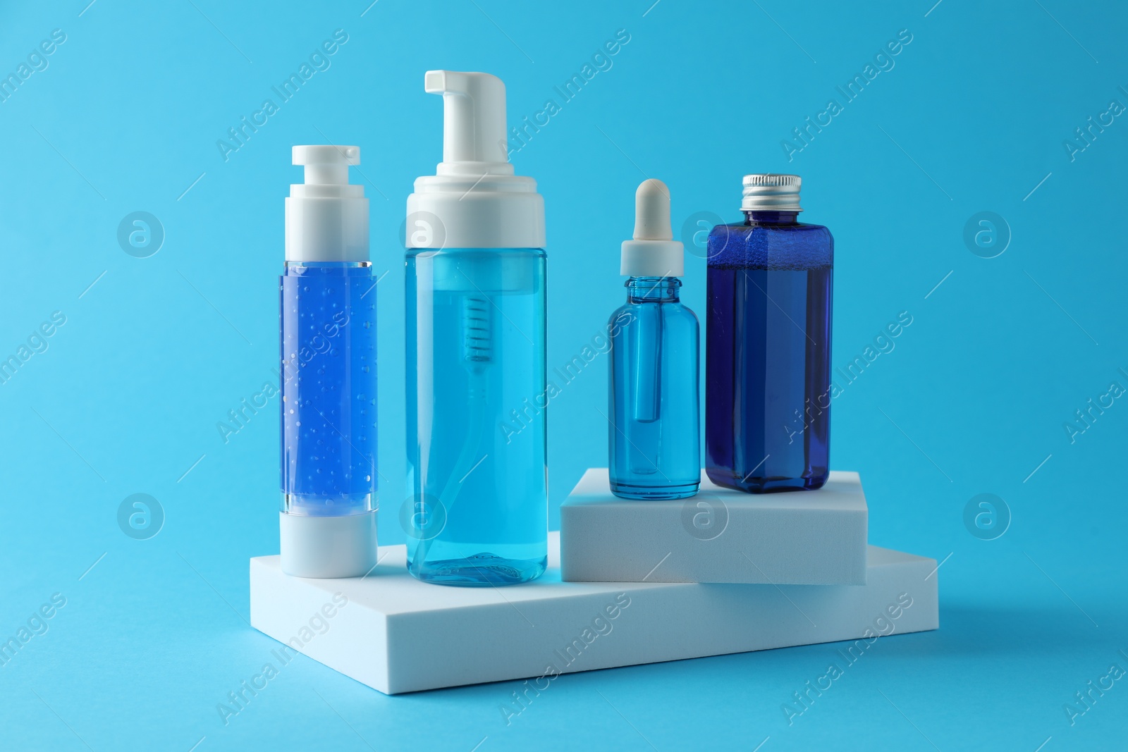 Photo of Set of luxury cosmetic products on light blue background