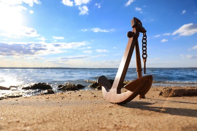 Photo of Wooden anchor near river on sunny day