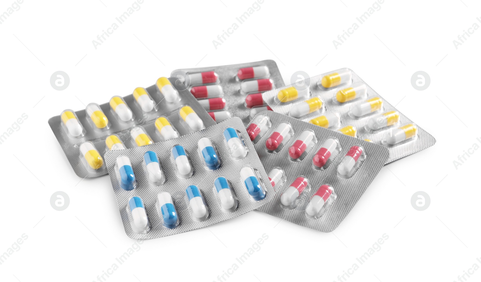 Photo of Many blisters with different pills on white background