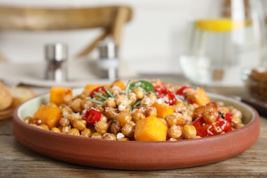 Photo of Delicious fresh chickpea salad on wooden table