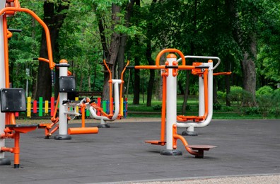 Photo of Empty outdoor gym with chest press machine, twister, ovate stepper and air walker