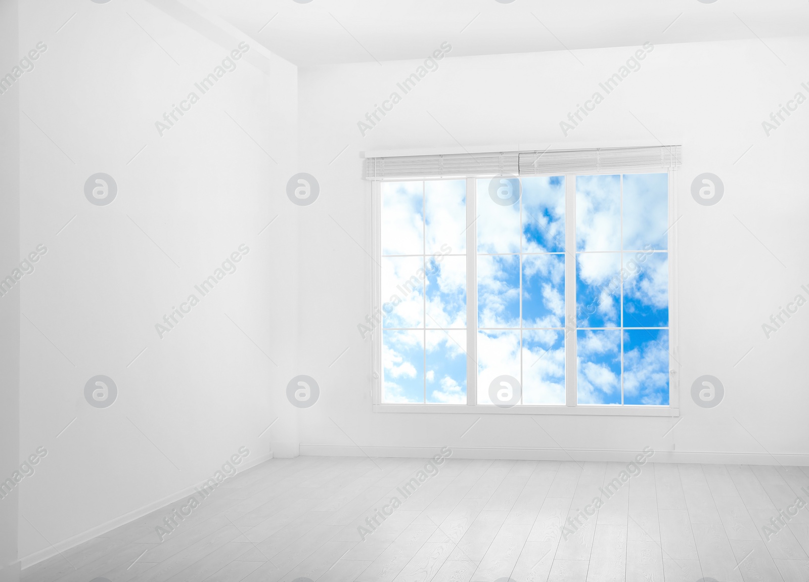 Image of Beautiful view on blue sky with clouds through window in room