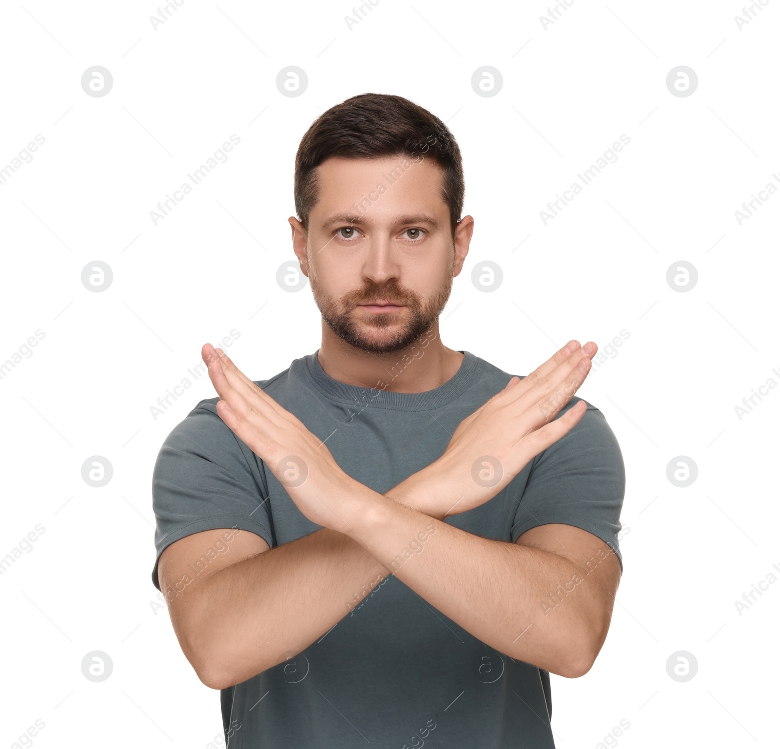 Photo of Handsome man with crossed hands isolated on white. Stop gesture