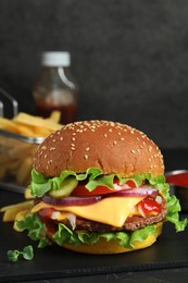 Delicious burger with beef patty on dark table, closeup